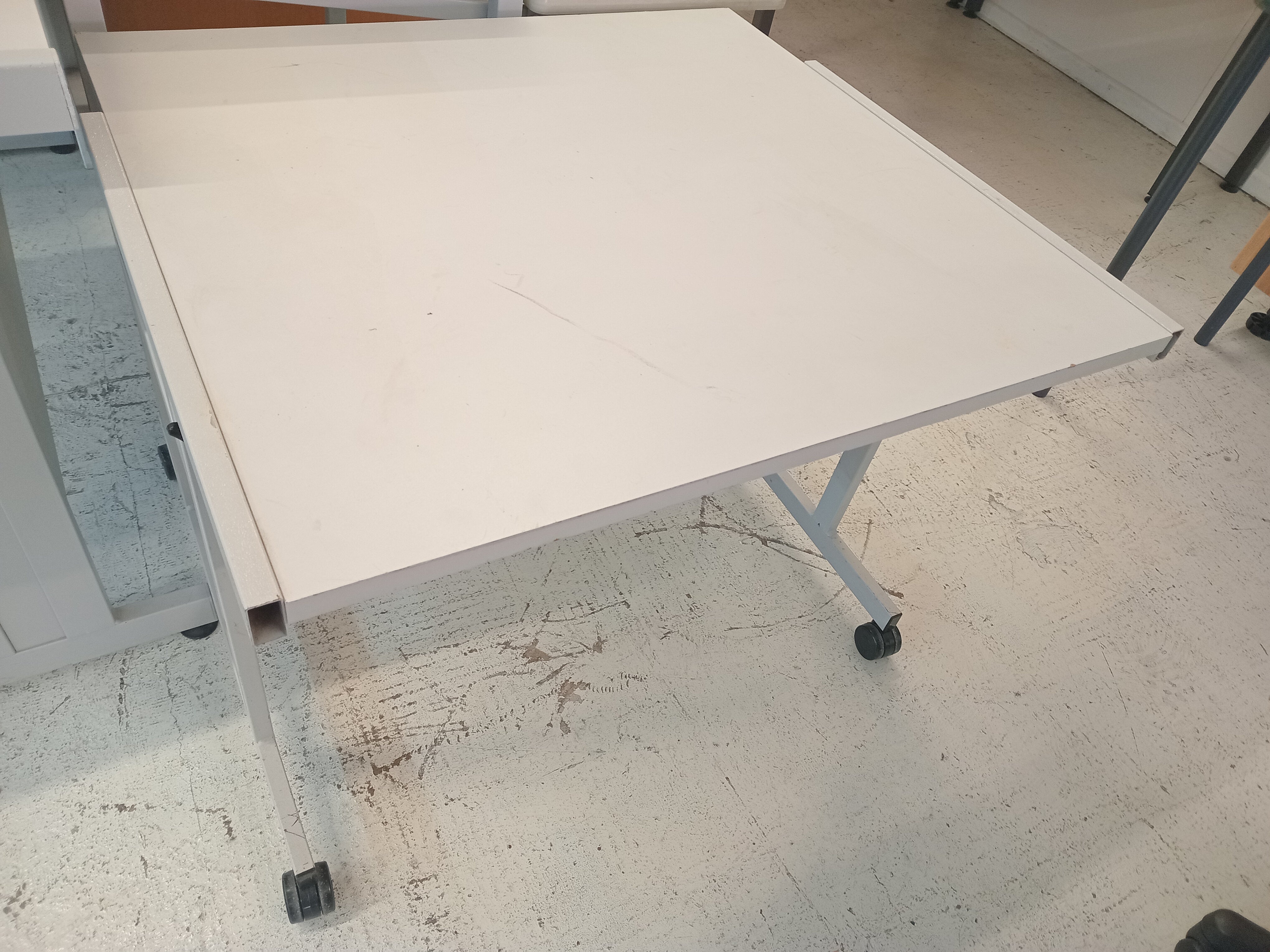 Small grey desk on wheels